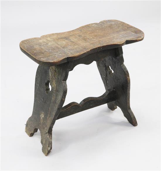 A 16th century and later oak boarded stool, W.1ft 9in.